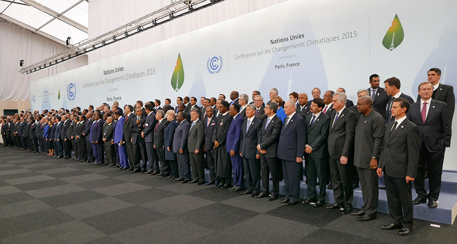 Photo of a lot people in suits, mostly men, head of delegations at the 2015 United Nations Climate Change Conference (COP21) in Paris